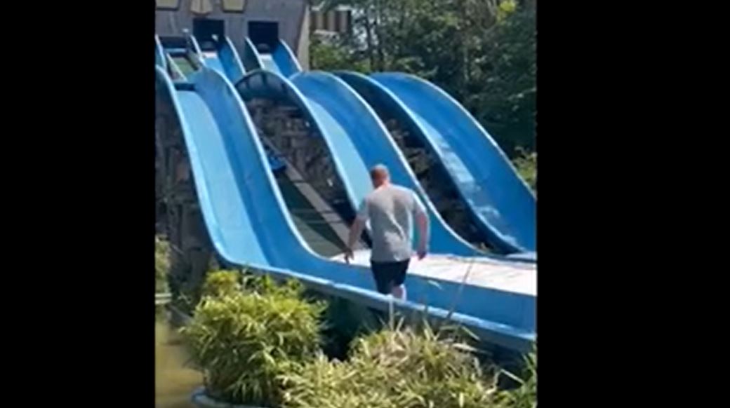Video shows father climbing up theme park's water slide to rescue